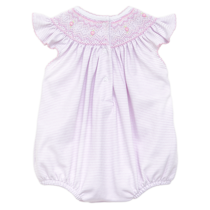 Baby romper with smocked details on a white background