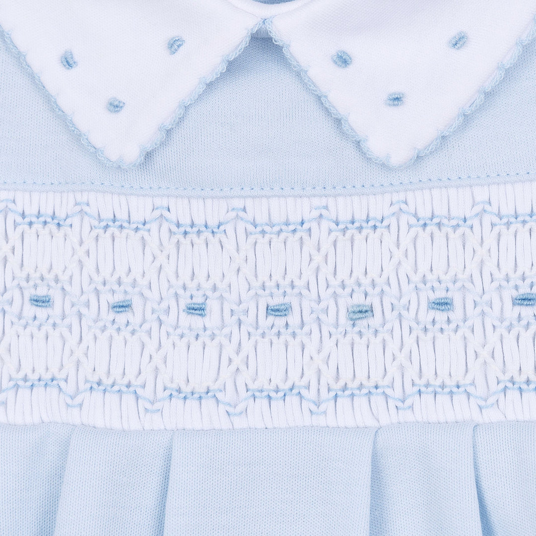 Close-up of a light blue fabric with intricate stitching pattern