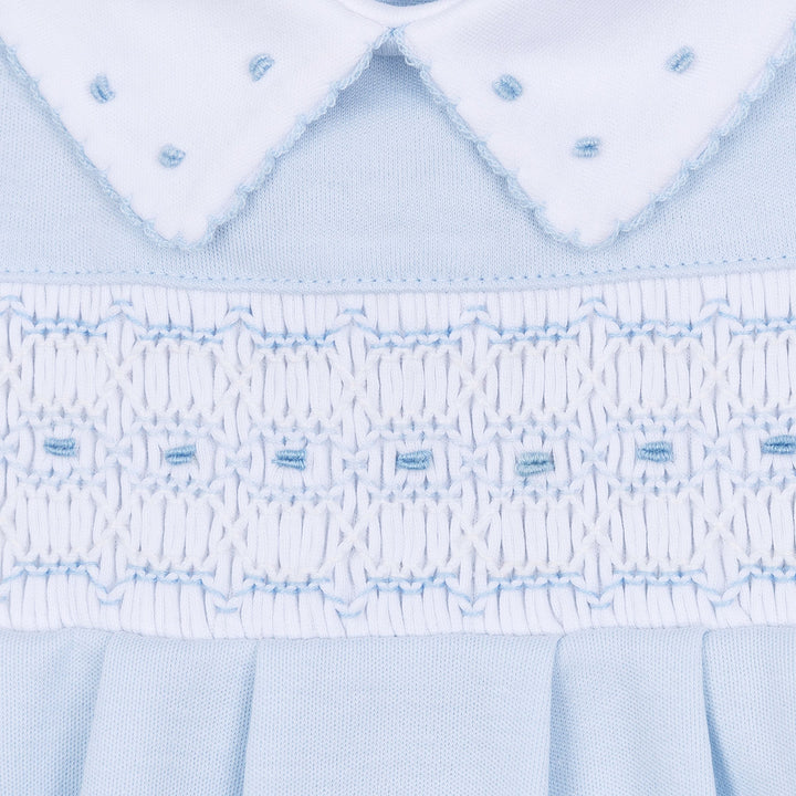 Close-up of a light blue fabric with intricate stitching pattern
