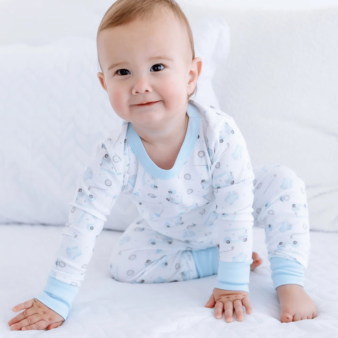 Baby wearing a light blue and white patterned outfit on a white background