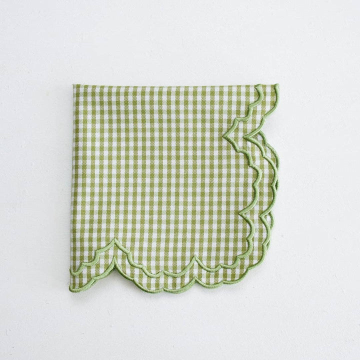Green checkered napkin with scalloped edge on a white background