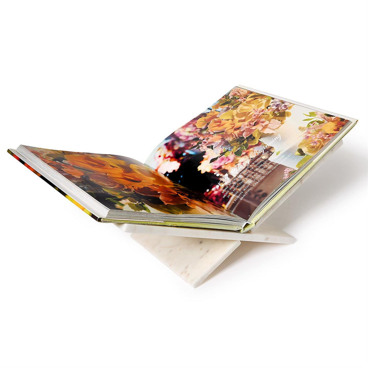 a marble book stand displaying a coffee table book