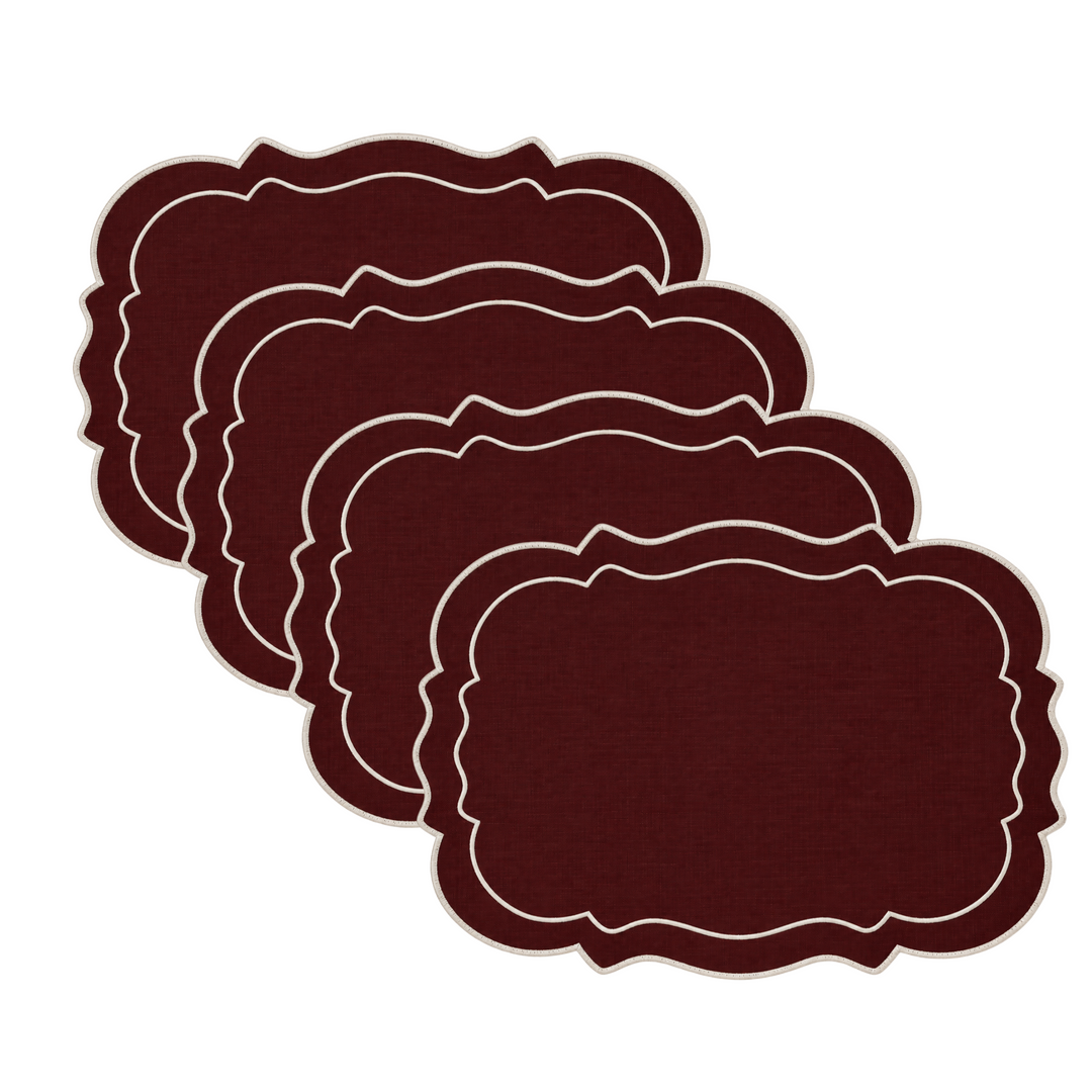 Six dark burgundy placemats with a white scalloped border, arranged in a fanned stack on a plain white background.
