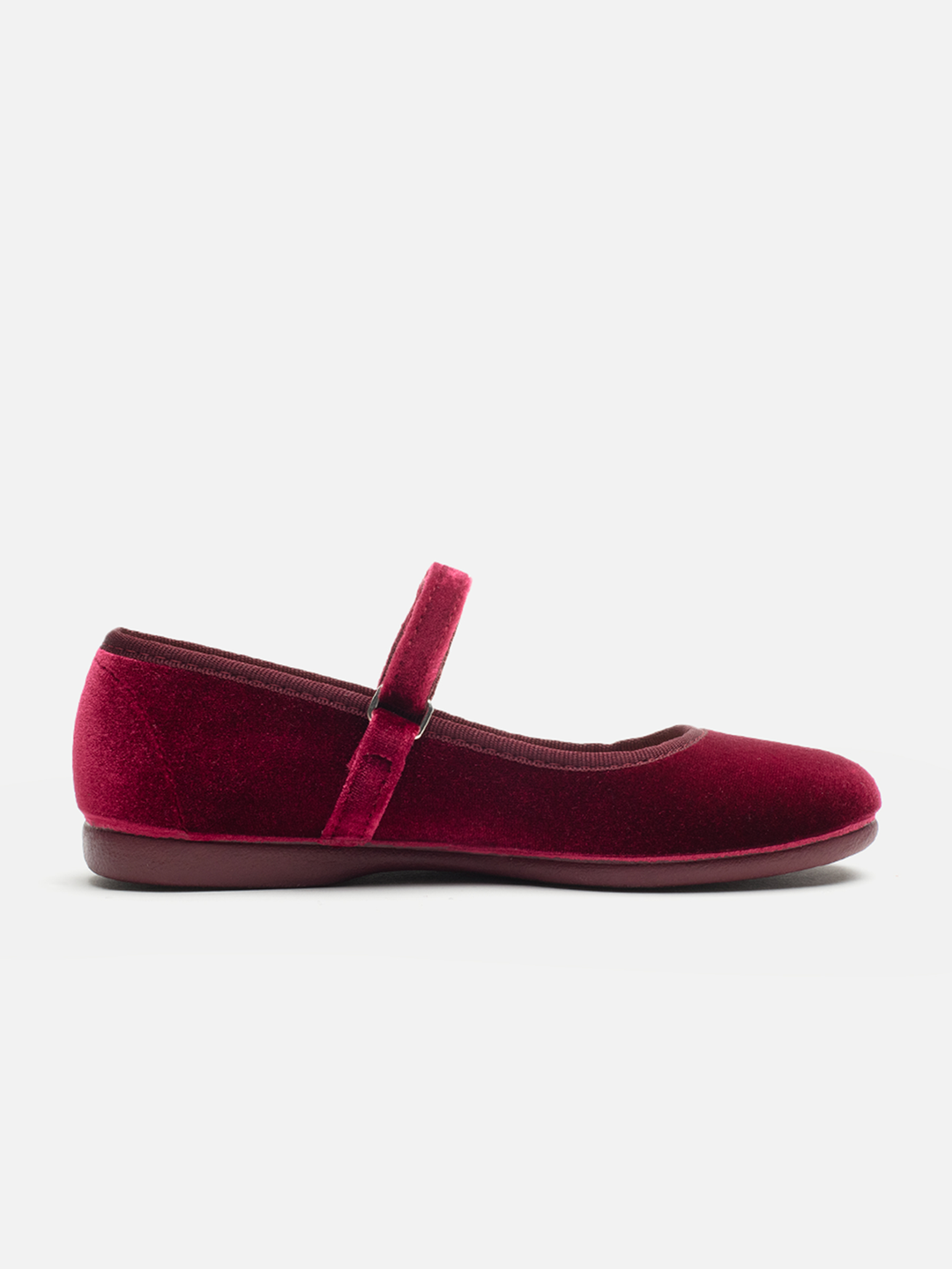 A single deep burgundy velvet Mary Jane flat shoe with a matching velvet strap and a dark brown sole, shown in profile against a light gray background.