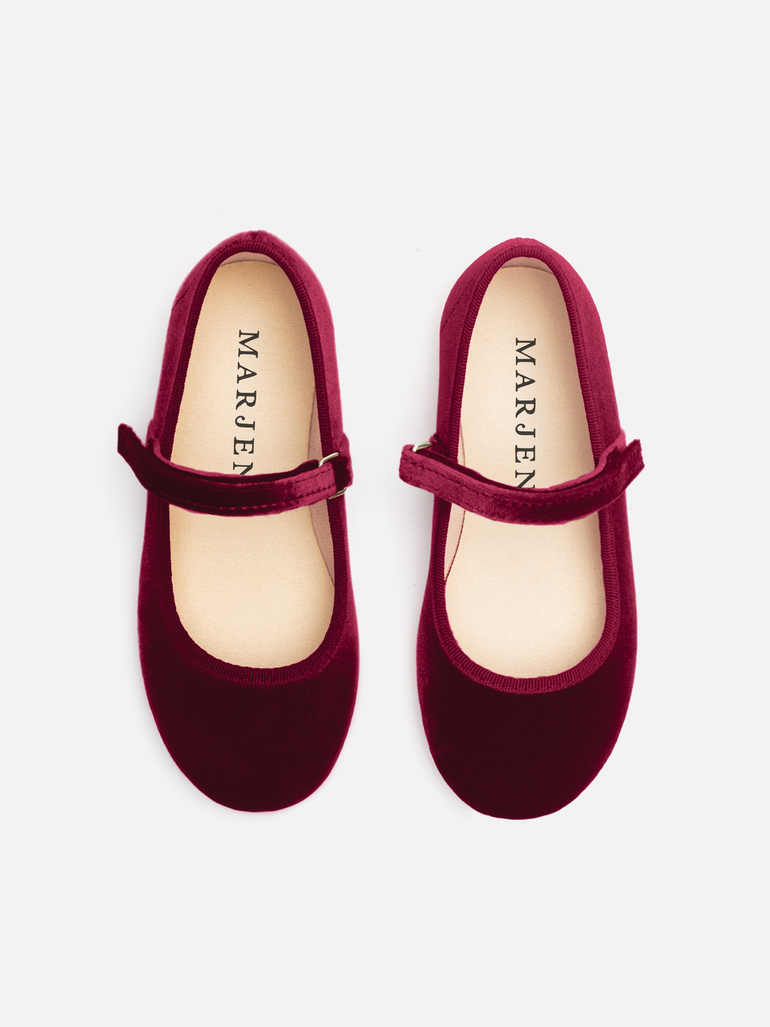 A pair of burgundy velvet Mary Jane shoes with a matching velvet strap and a light beige insole, shown from a top-down view on a light gray background. The brand name 'MARJEN' is printed on the insole.