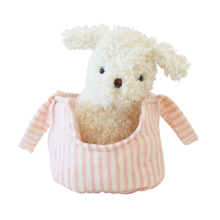 Stuffed animal in a pink and white striped bag on a white background
