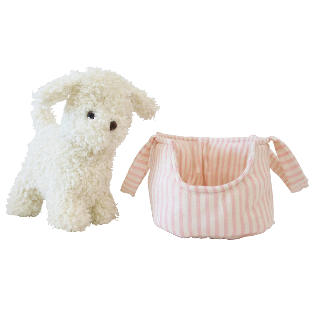 White plush dog toy next to a pink striped pet bed on a white background