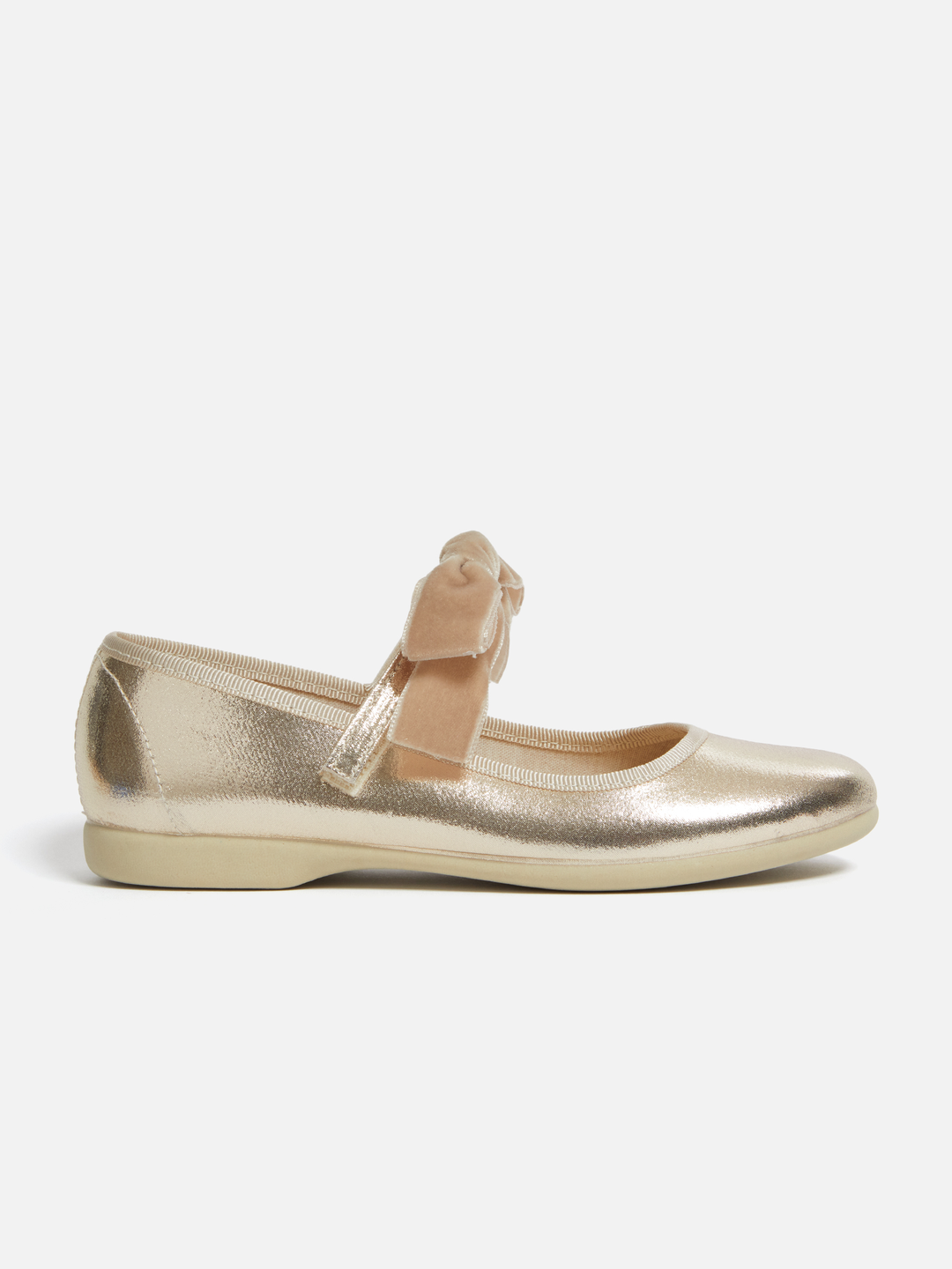 A single metallic gold Mary Jane flat shoe with a beige ribbon bow on the strap, shown in profile against a light gray background.
