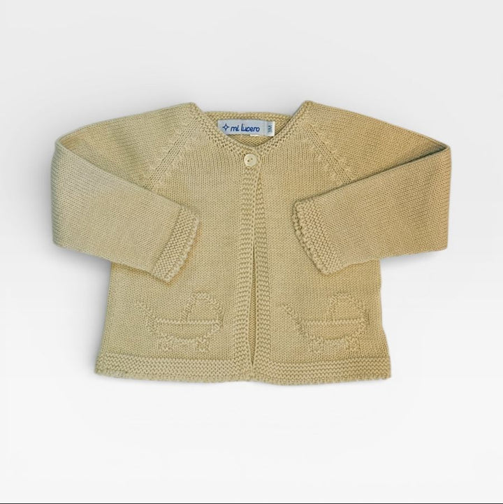 A light beige knit cardigan sweater for babies, featuring long sleeves, a single button closure, and knitted boat motifs on the front, displayed flat against a light gray background.