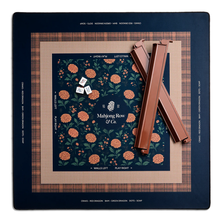 Mahjong game set with floral design on a grid surface, featuring 'Mahjong Row & Co.' branding.