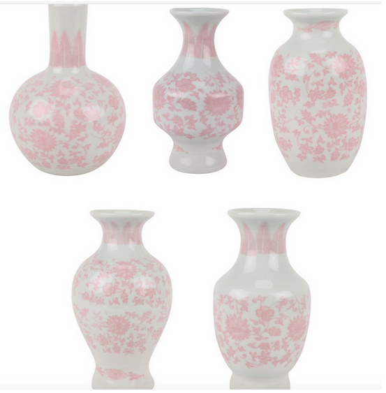 Set of five white vases with pink floral patterns on a white background
