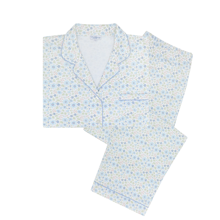 A two-piece pajama set featuring a light blue and white floral print with matching piping, laid flat on a white background.