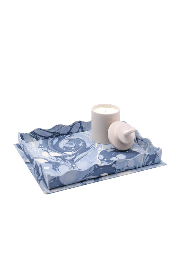 Blue and white marbled tray with a candle on a white background