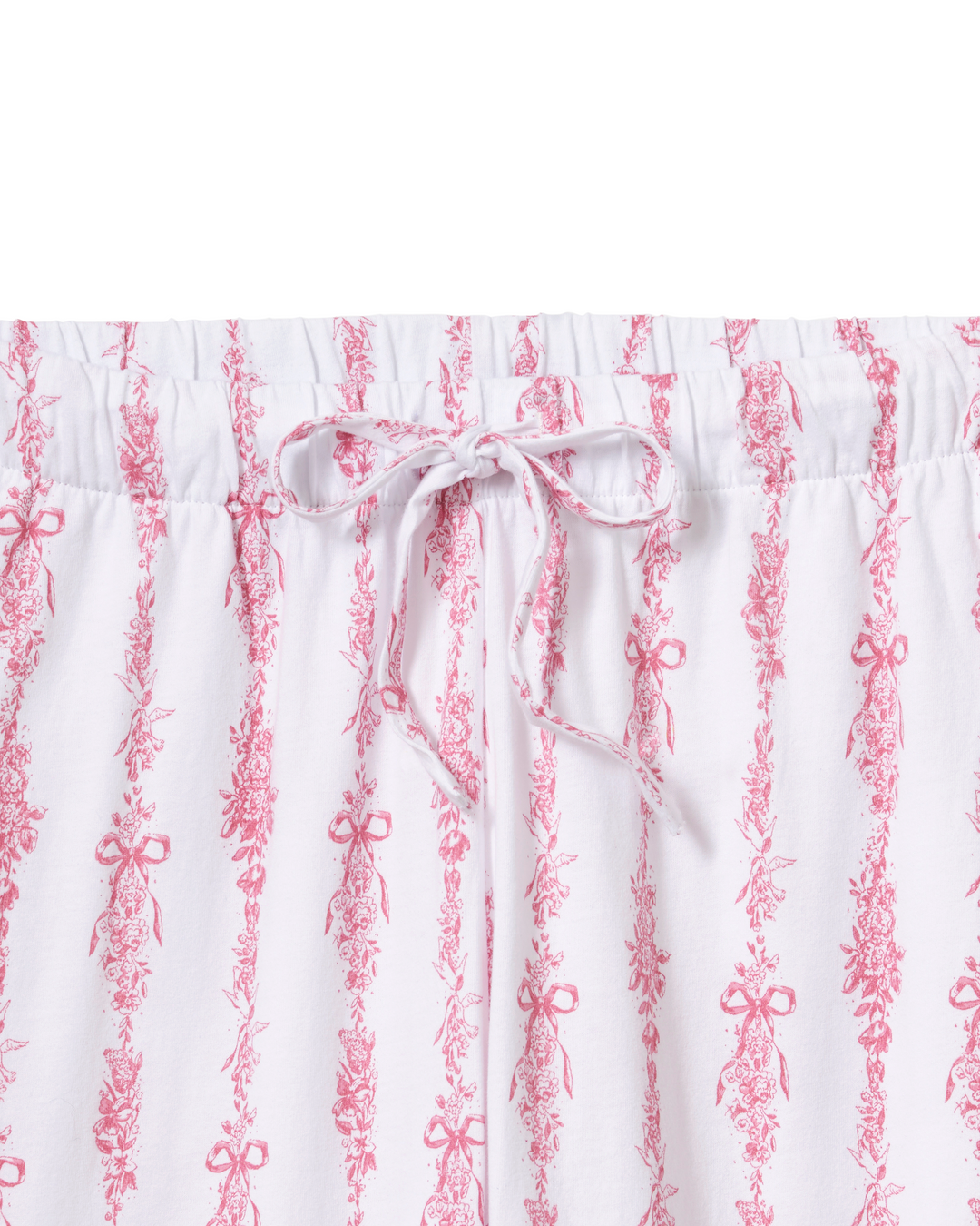 White drawstring shorts featuring a vertical pink toile-style pattern of bows and floral motifs, shown against a plain white background.