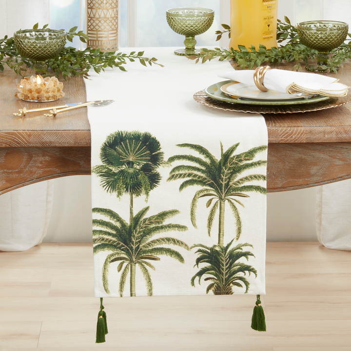 Table setting with a palm tree patterned table runner on a wooden table.