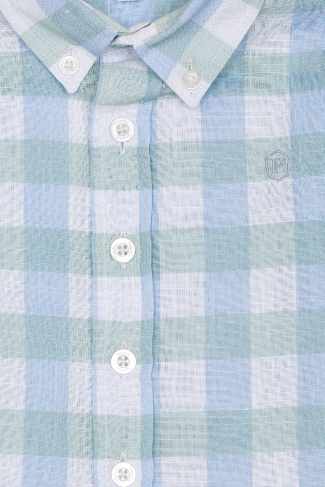 Close-up of a light blue and green checkered shirt with buttons.