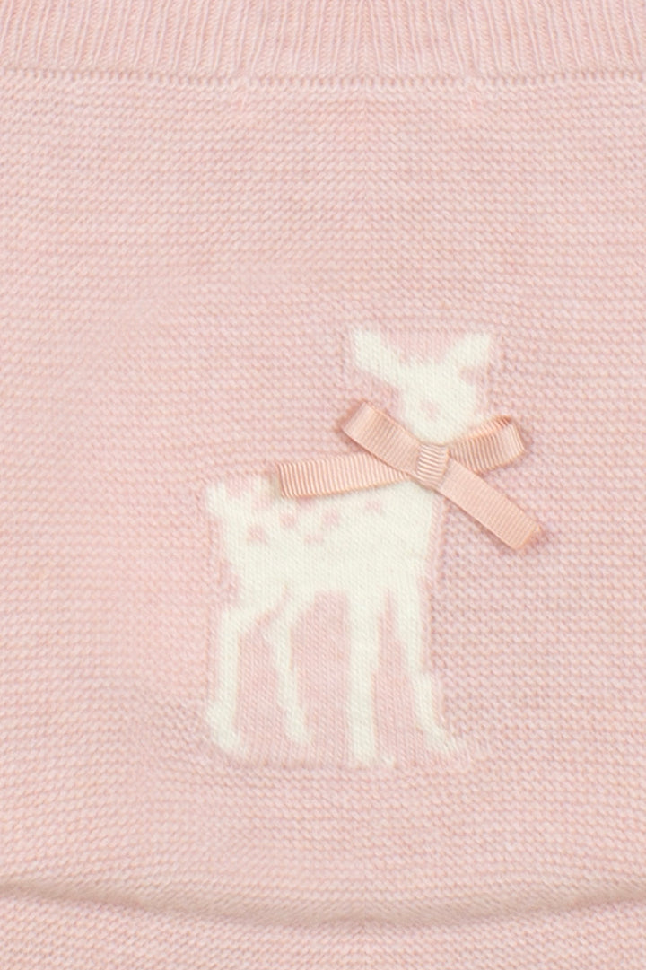 Close-up of a light pink knitted garment featuring a white knitted deer motif with a matching pale pink ribbon bow.