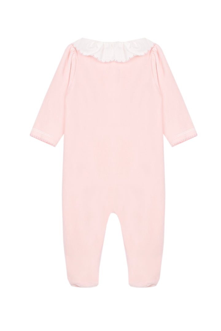 A light pink baby jumpsuit with long sleeves, footless legs, and a contrasting white ruffled collar, shown against a plain white background.
