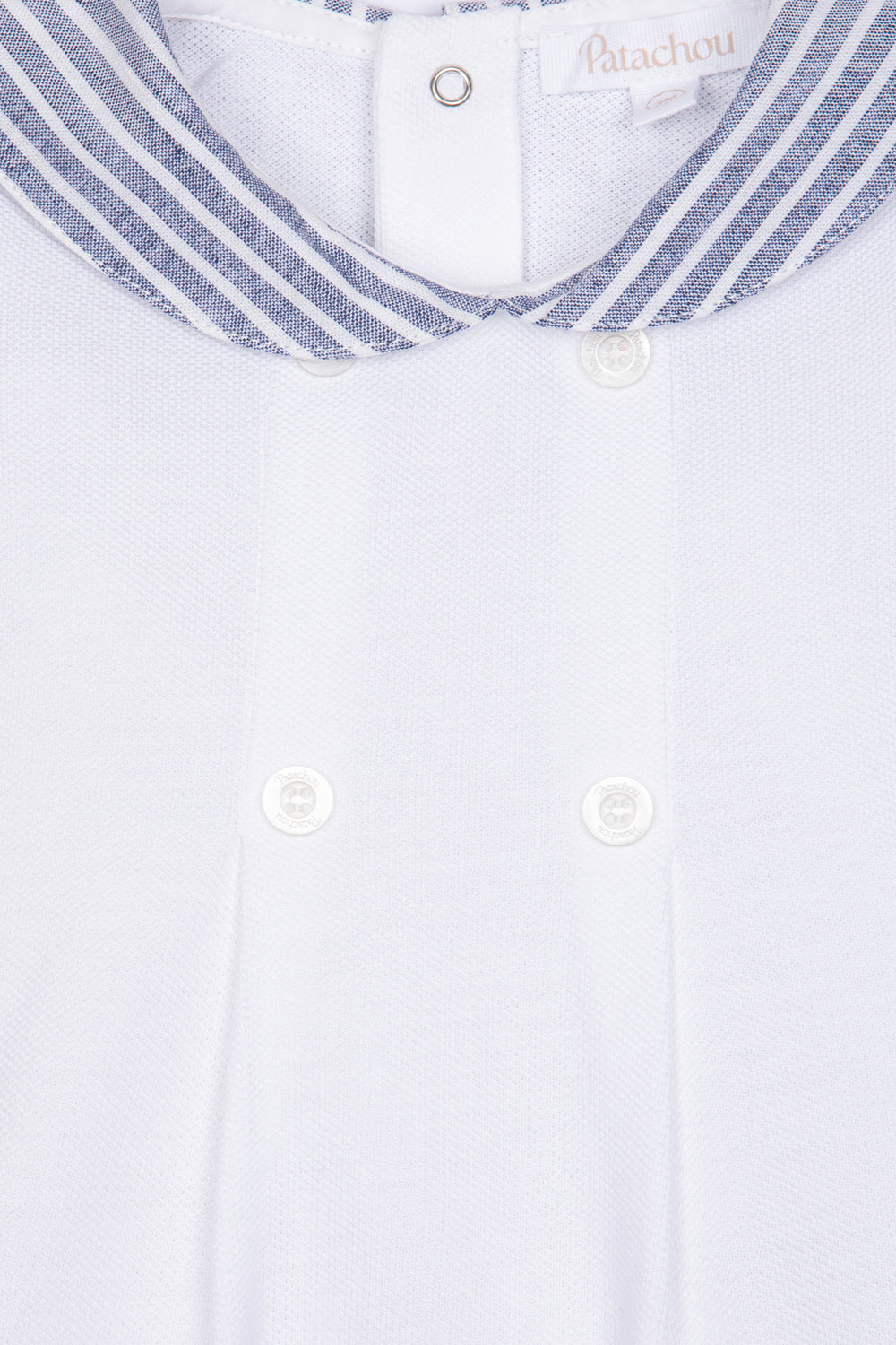 Close-up of a white shirt with a striped collar and buttons, featuring the brand 'Bianchi'.