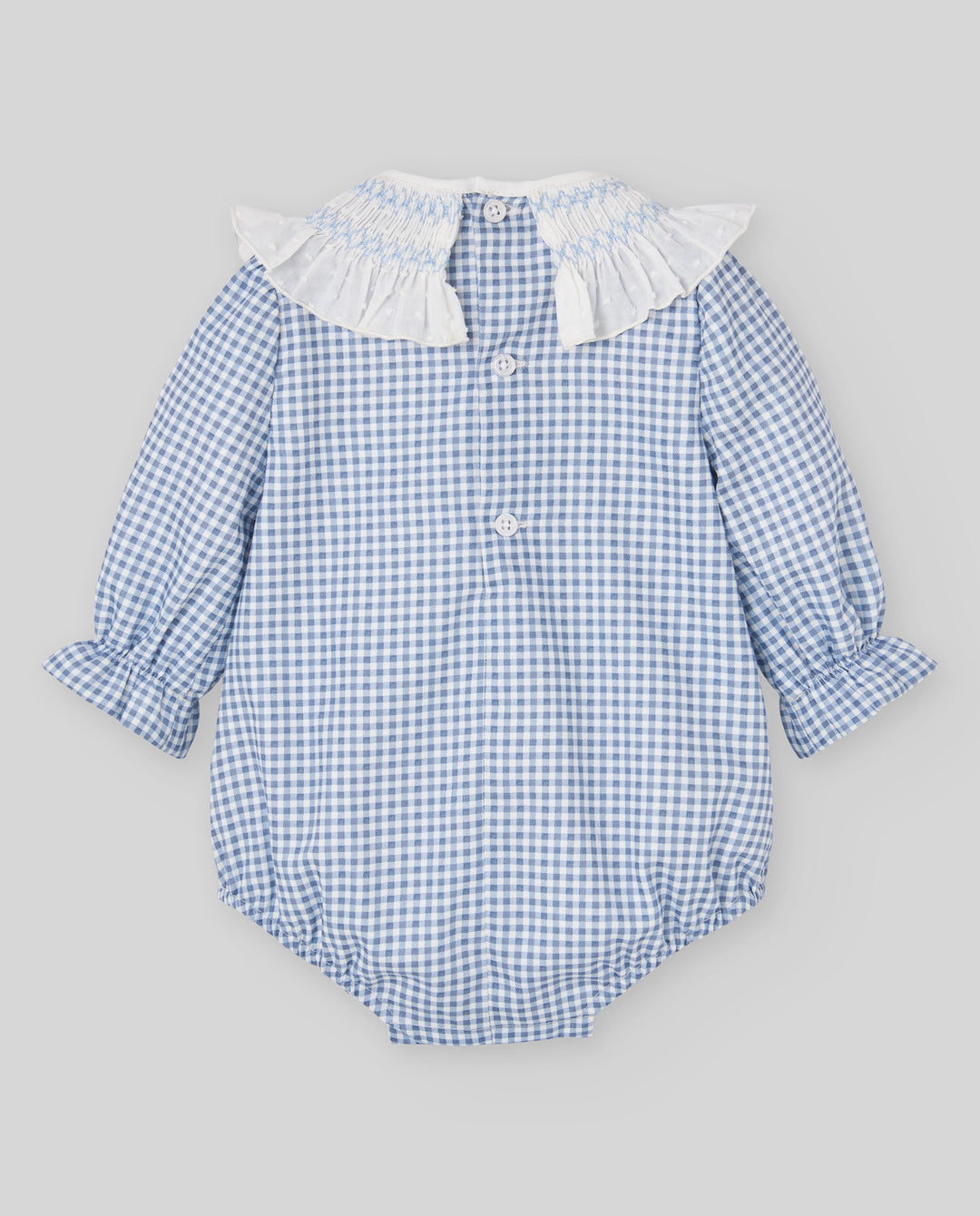 A baby long-sleeve romper in a light blue and white gingham pattern, featuring a white ruffled collar and button details, laid flat on a neutral gray background.