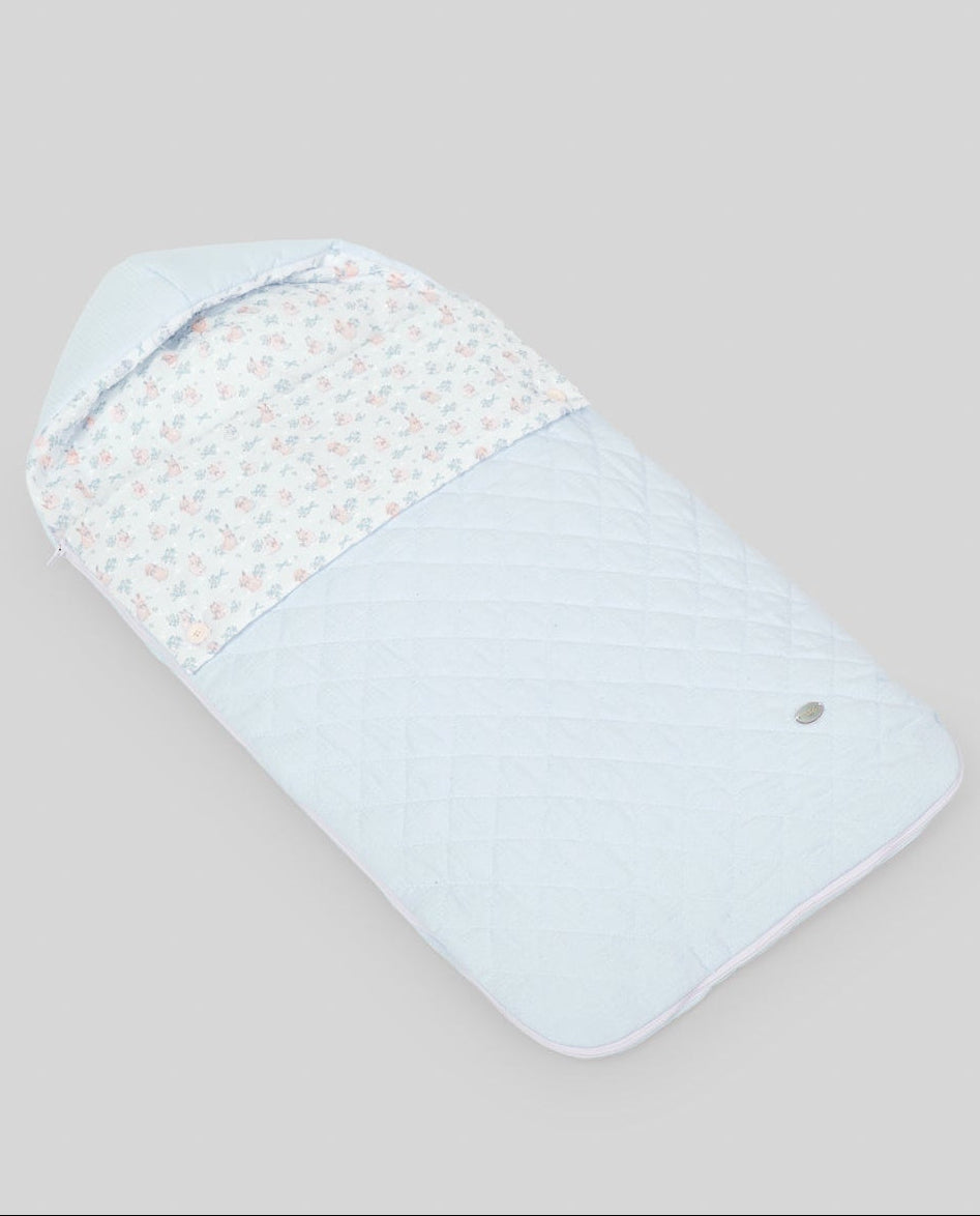 Baby swaddle with light blue and white pattern on a beige background