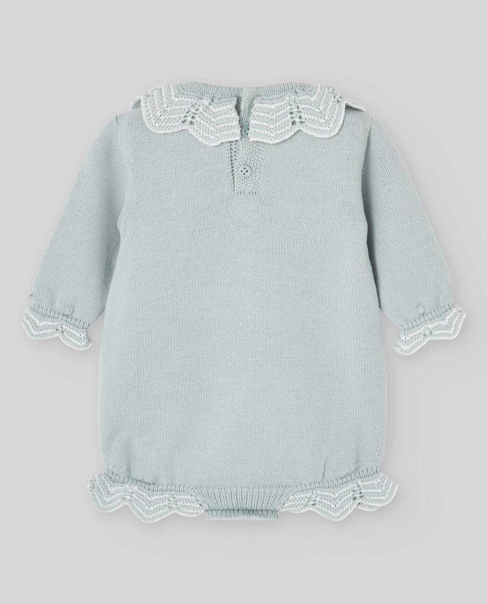 A light sage green baby knit romper with white lace trim on the collar, cuffs, and hem, displayed flat against a neutral gray background.