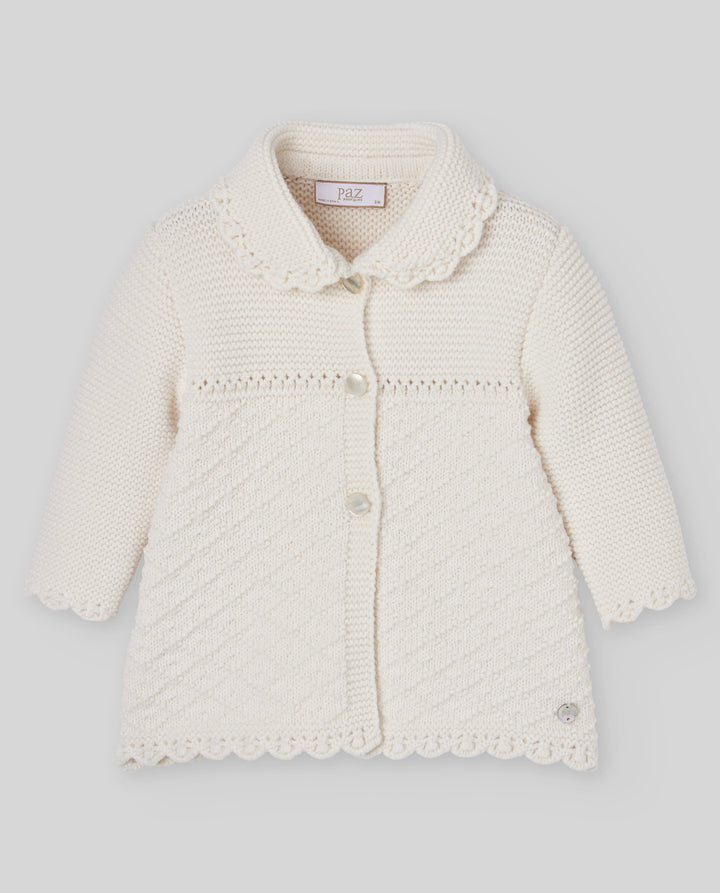 An off-white cream knitted cardigan for toddlers, featuring a Peter Pan collar, scalloped edges, and a front button closure, shown against a neutral gray background.