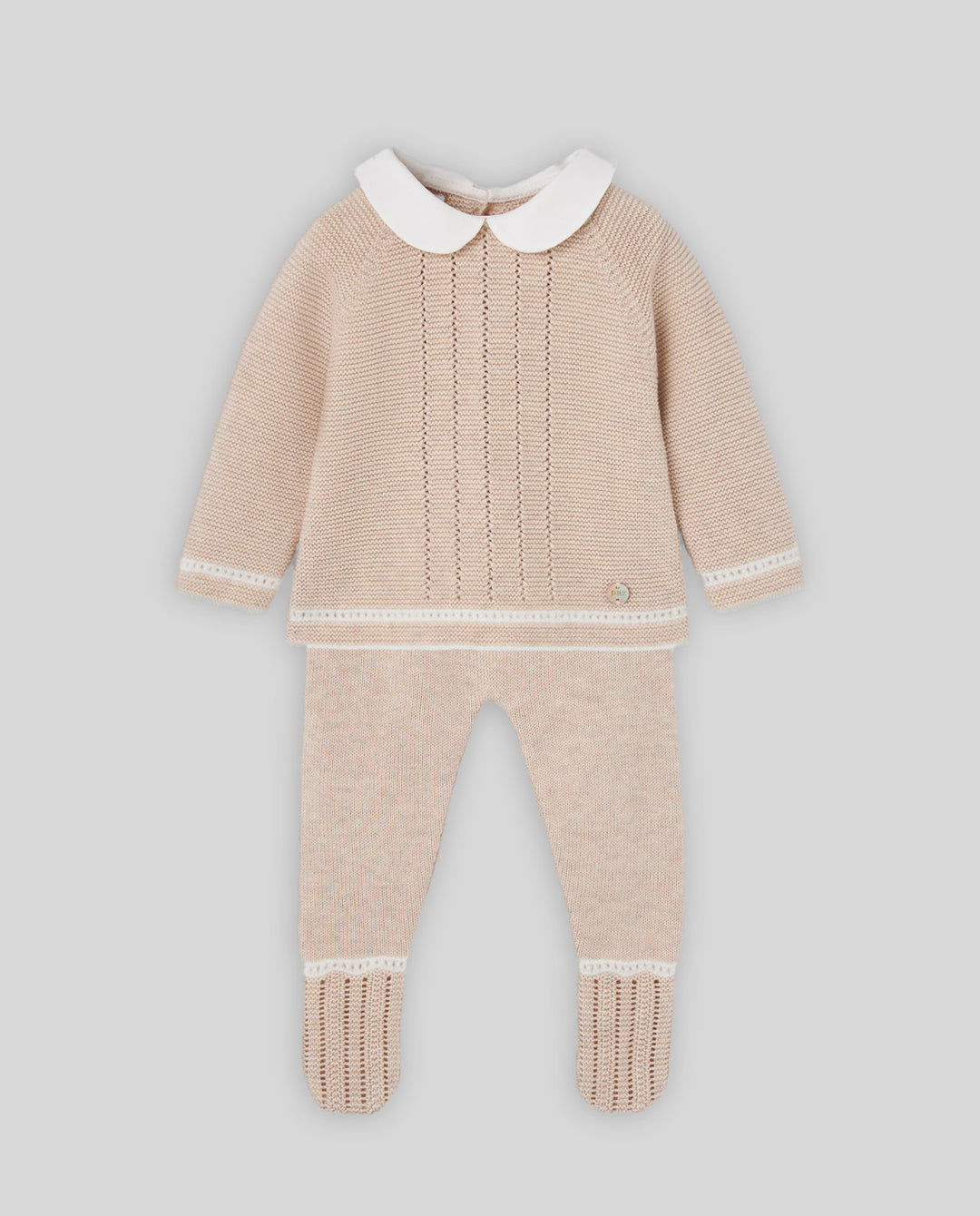 A baby knit two-piece outfit featuring a long-sleeve top with a white Peter Pan collar and matching knit pants, in a light beige color with white trim details, shown against a solid gray background.