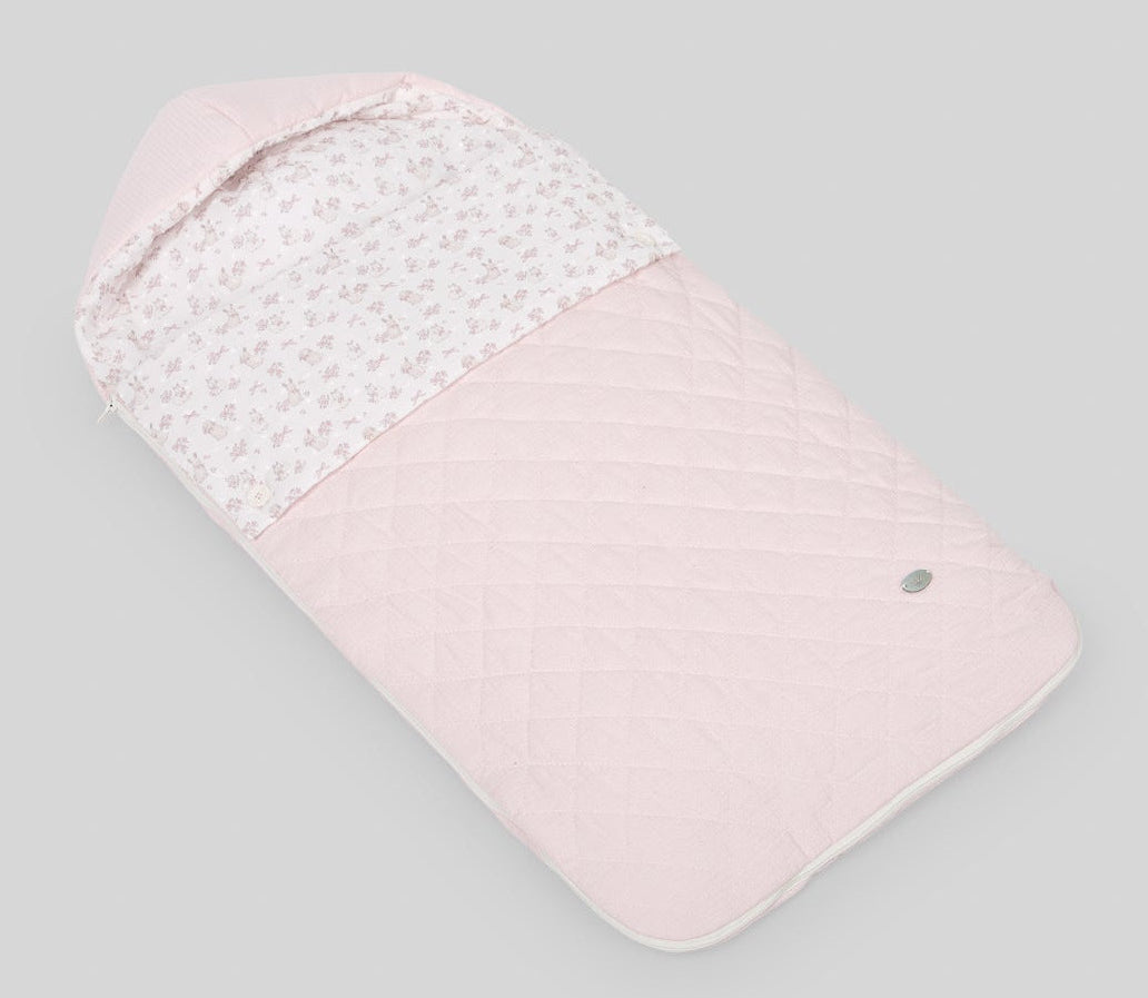 Pink baby swaddle with white pattern on a gray background