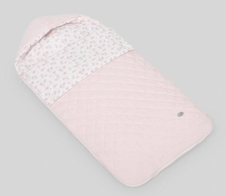 Pink baby swaddle with white pattern on a gray background