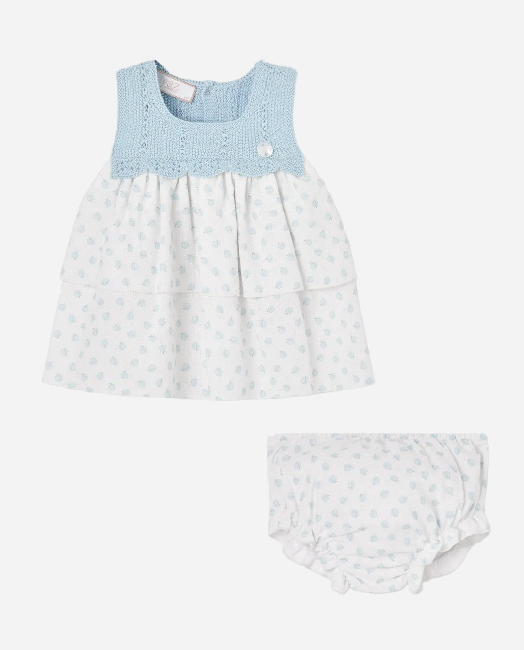 Baby dress with blue top and white bottom on a gray background