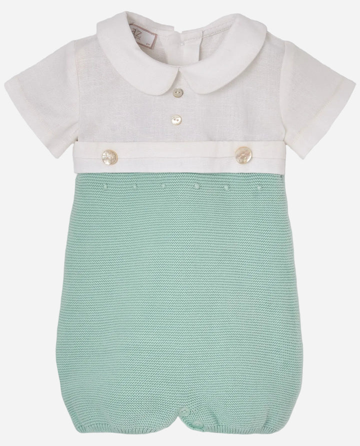 Baby romper with white shirt and green shorts on a light gray background