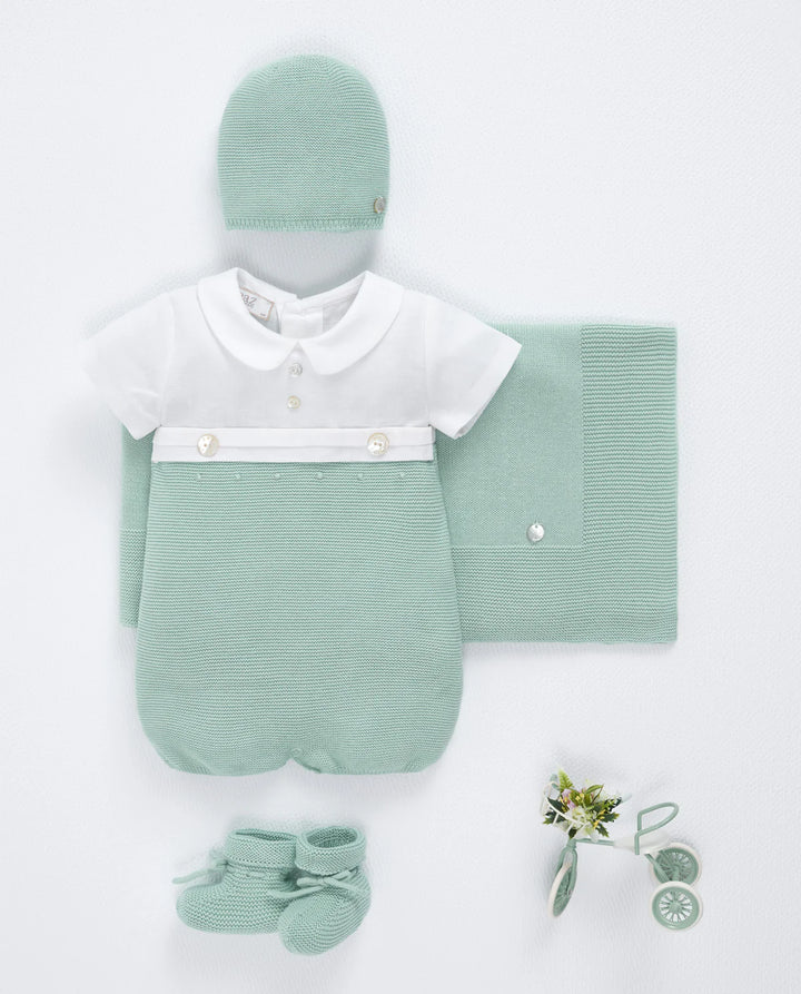 Green baby outfit with hat, blanket, and socks on a white background