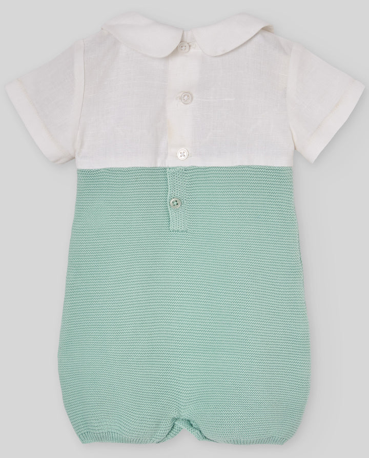 Green baby romper with white shirt on a light gray background