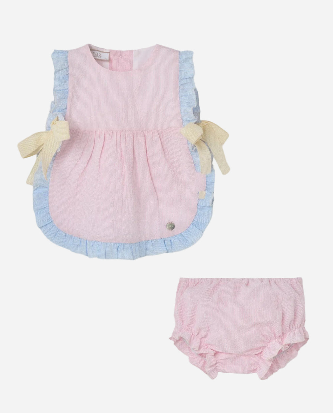 Pink baby outfit with ruffled trim on a light gray background
