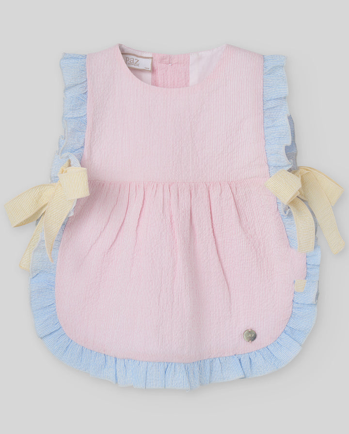 Pink dress with blue trim and yellow accents on a light gray background