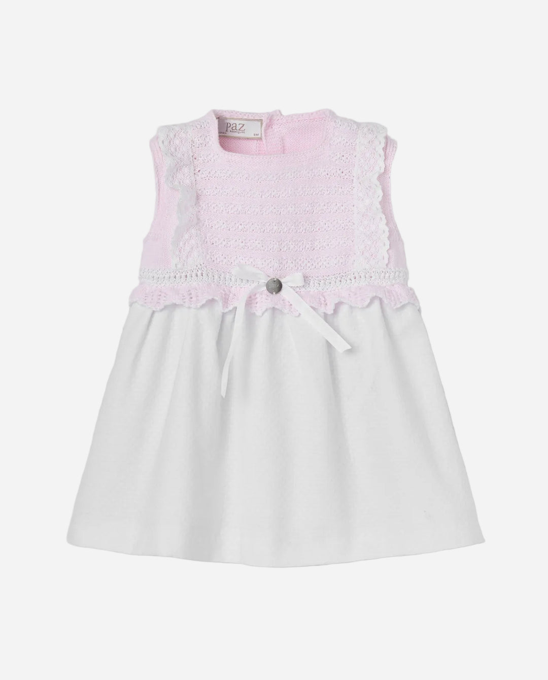 White dress with pink lace details on a light gray background