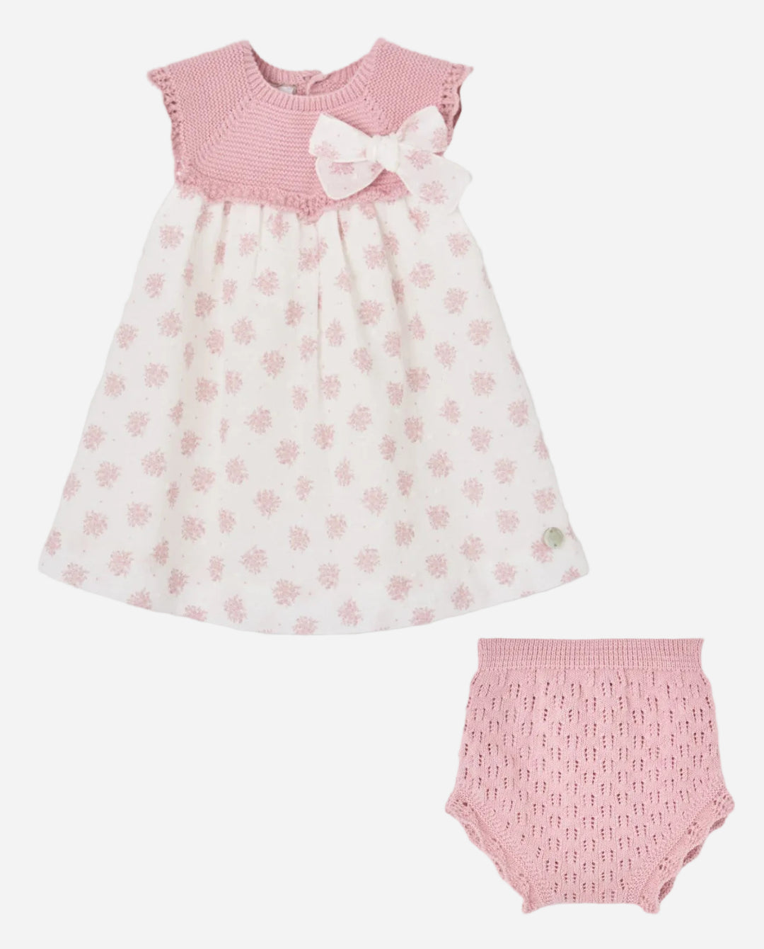 Baby dress with pink floral pattern and matching bloomers on a gray background
