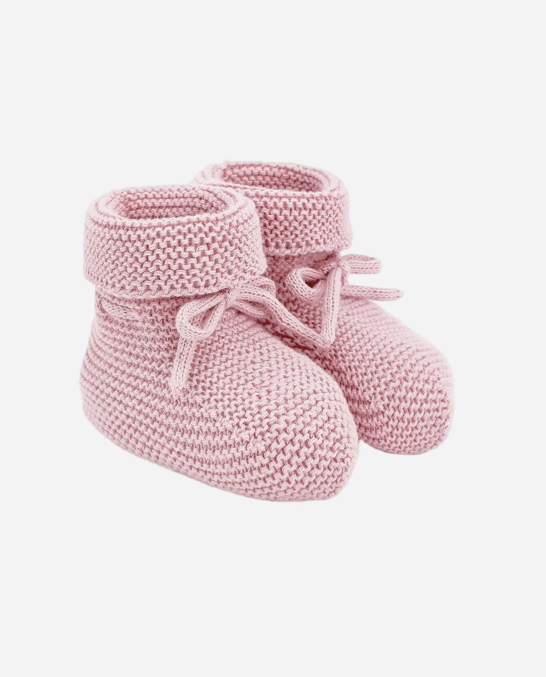 Pair of pink knitted baby booties on a gray background