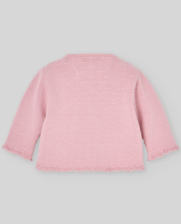 Pink textured cardigan on a light gray background