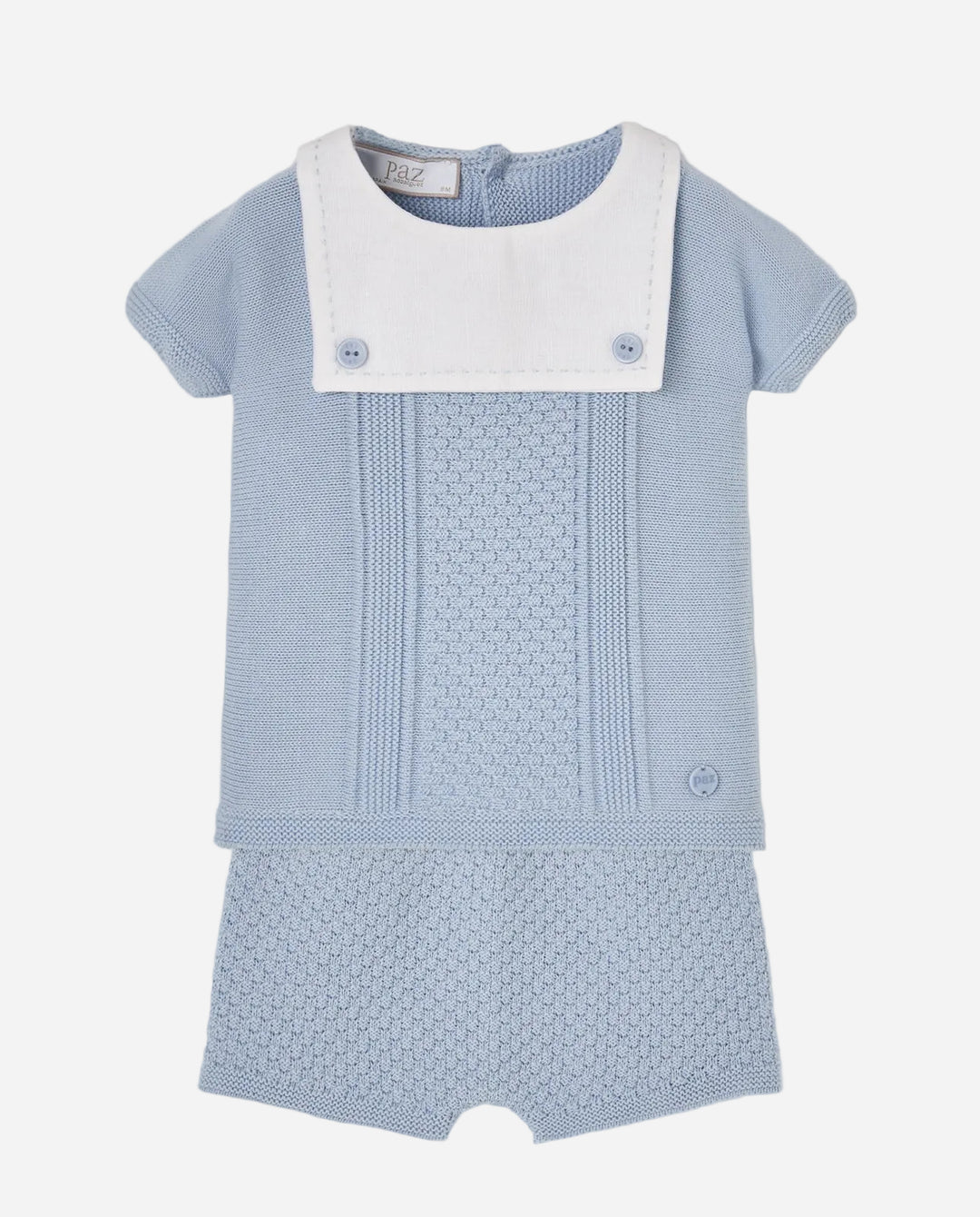 Blue knitted outfit with white collar on a light gray background