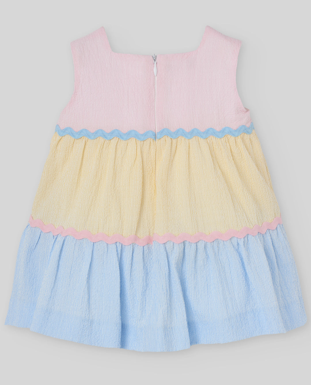 Color-blocked dress with pink, yellow, and blue on a light gray background