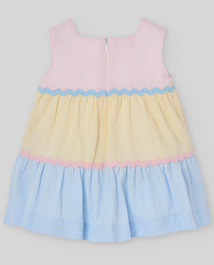 Color-blocked dress with pink, yellow, and blue on a light gray background