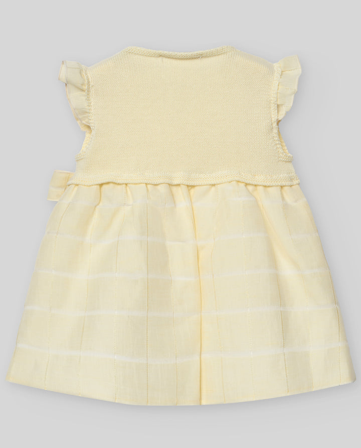 Yellow dress with a checkered pattern on a gray background