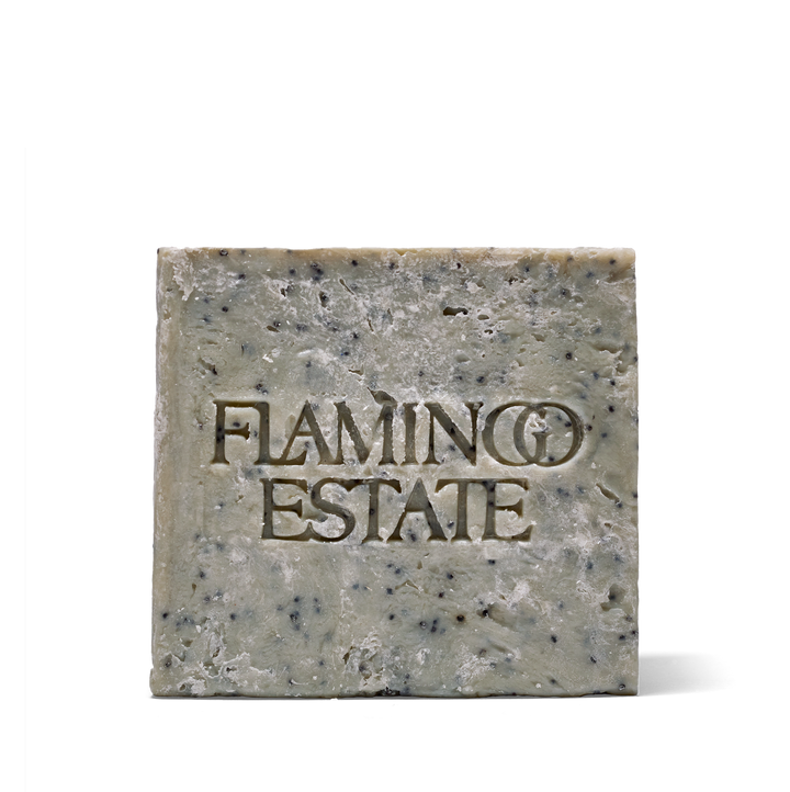 A single rectangular bar of soap with the brand name 'FLAMINGO ESTATE' embossed on the front, shown against a plain white background.