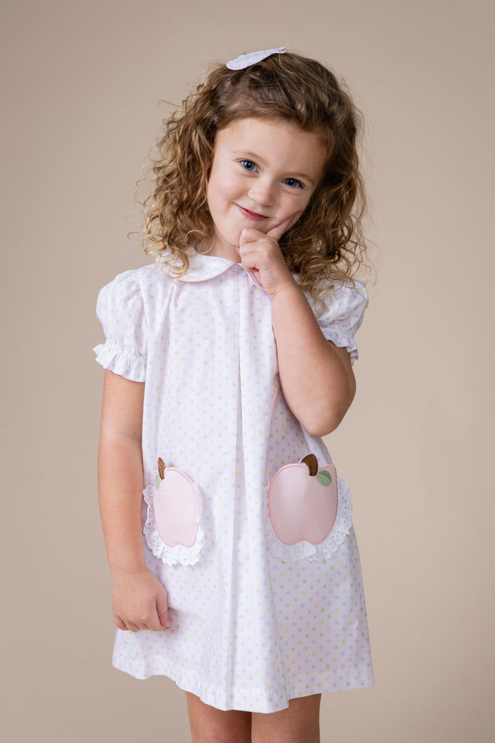 Girl wearing apple print white bitty dress
