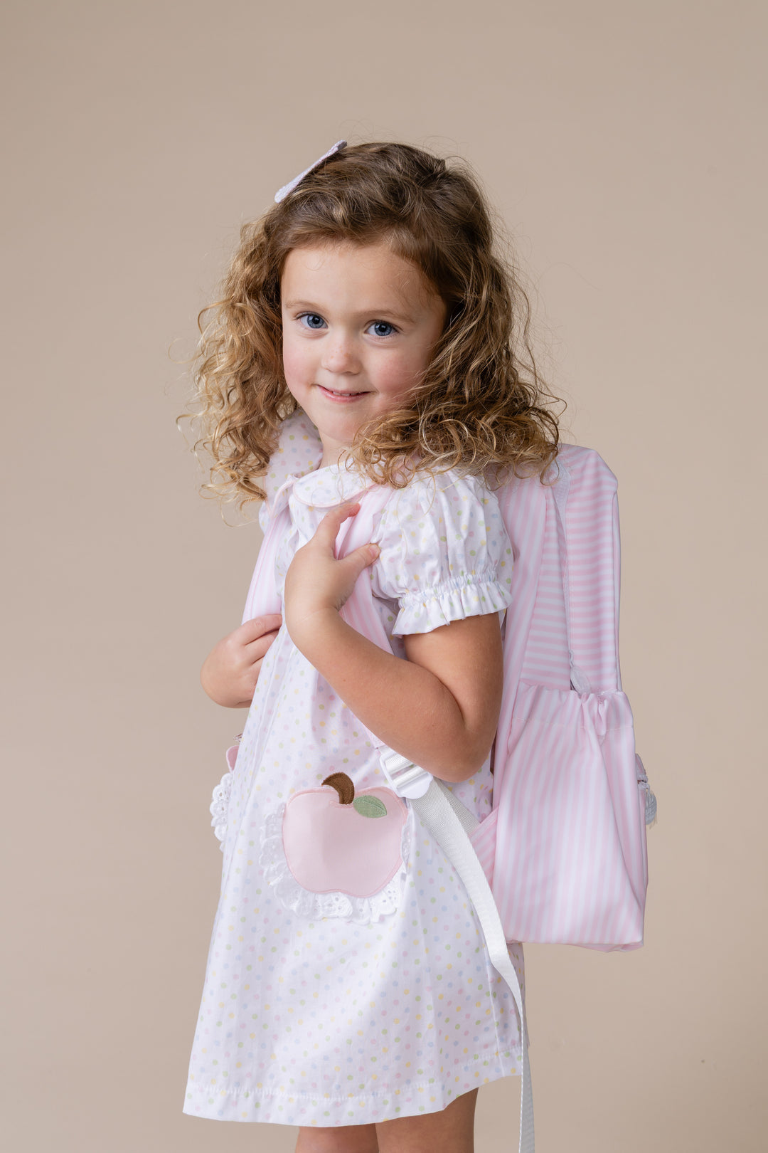girl wearing back to school dress with backpack
