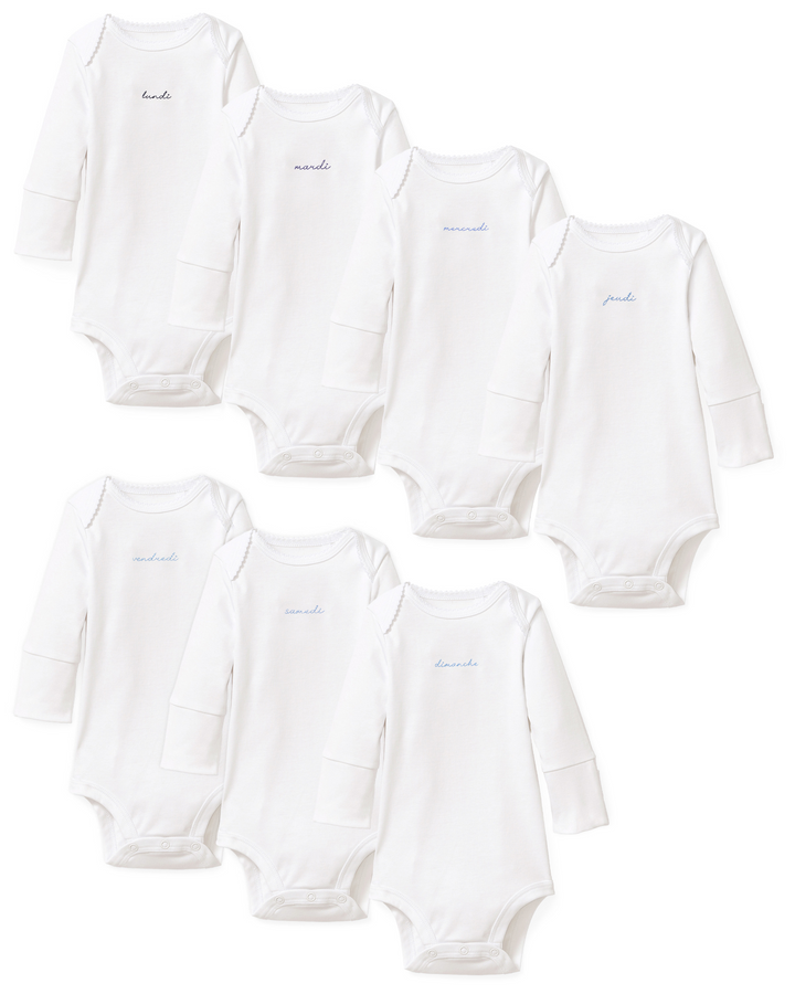 Six white long-sleeve baby bodysuits arranged in two rows on a plain white background, each with a small embroidered name on the chest.