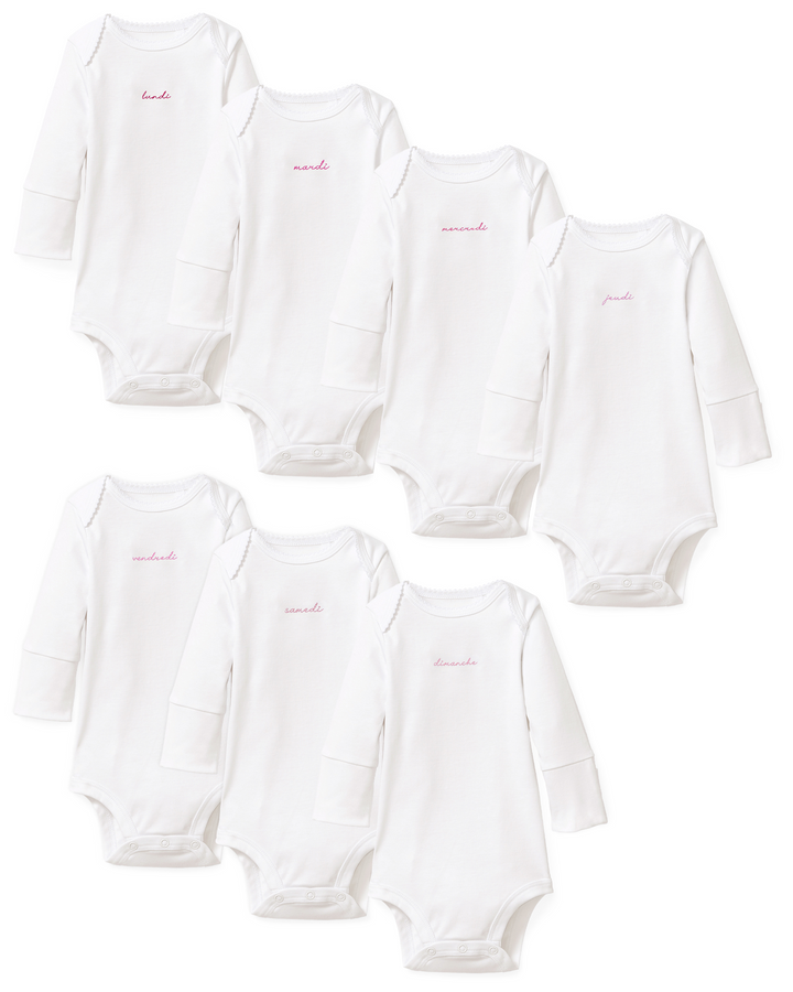A set of eight white long-sleeve baby bodysuits arranged in two rows on a plain white background. Each bodysuit has a small pink embroidered script logo on the chest.