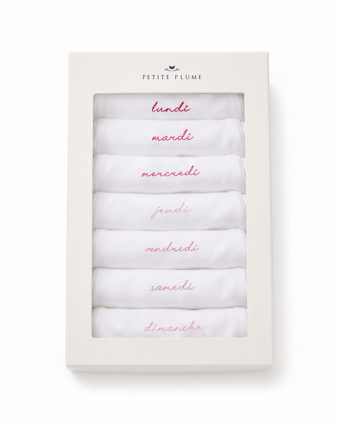A boxed set of six folded white baby blankets or swaddle blankets with pink handwritten day names in Italian, presented in a cream-colored rectangular gift box labeled Petite Flôme.